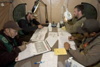 Four U.S. Fish and Wildlife Service biologists reviewing data around a table.