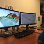 Someone viewing data imagery on two desktop monitors.