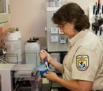 Woman in laboratory processing samples.