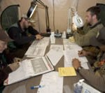 Four U.S. Fish and Wildlife Service biologists reviewing data around a table.