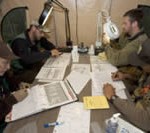 Four U.S. Fish and Wildlife Service biologists reviewing data around a table.