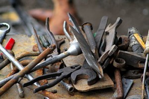 a pile of metal tools on a workbench