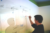 Man writing on a whiteboard.